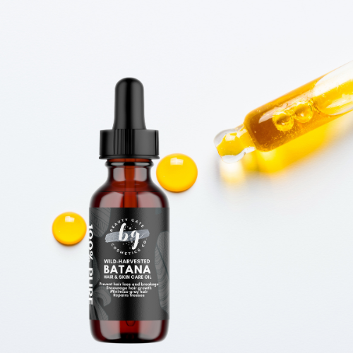 Product shot of a brown glass bottle with a black dropper, showcasing 'Batana Hair & Skin Care Oil' with two yellow droplets and a dropper with the same colored oil.