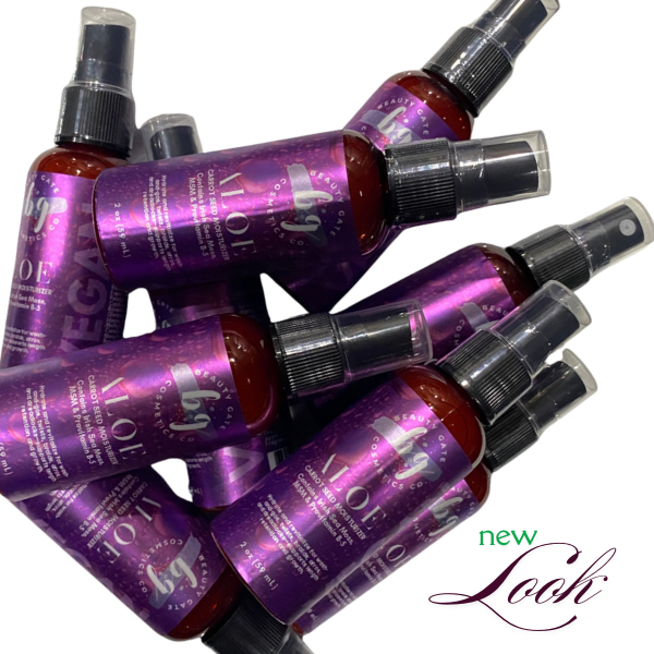 Pile of purple beauty product bottles with clear spray nozzles. "New look" text in the corner.