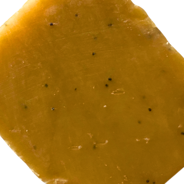 Square bar of yellow soap with black flecks.
