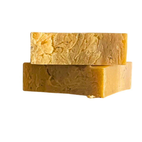 Two rectangular bars of yellow, textured soap stacked on top of each other.

