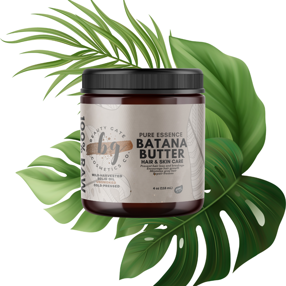 Brown jar of Batana Butter surrounded by green tropical leaves.
